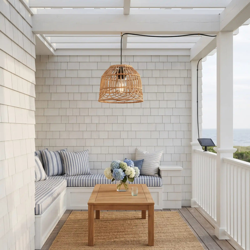PT0913 solar rattan pendant light hanging over a coastal outdoor patio seating area