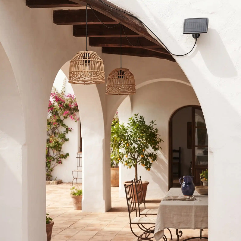 PT0914 solar rattan pendant lights glowing in an outdoor glass garden room at night