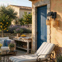 Outdoor solar light with natural weave shades next to blue door in Mediterranean garden