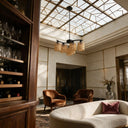 Natural bamboo light fixture above lounge area in desert adobe patio with mountain view