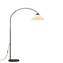 A modern floor lamp with a black arched metal stand, a round dark base, and a pleated white shade that glows warm white when lit, shown on a plain white background.
