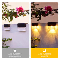 Two outdoor wall-mounted solar lights shown side by side in a split comparison. The left panel shows the lights unlit against a white wall with flowering branches above, captioned 'Auto TURN OFF at the daytime.
