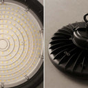 A split close-up of a high-bay LED pendant light, showing the underside with many small yellow LED chips on a white heat sink, and the black ribbed metal housing on the right.