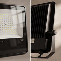 A split-view product photo of a black LED floodlight. The left panel shows a close-up of the front face with a grid of small LED chips, a white reflector, and the text 'LUX' and '70W'.