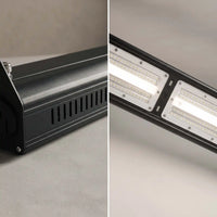 A split-view close-up of a black LED light bar fixture, showing the side profile with ventilation slots on the left and the illuminated LED panels on the right.