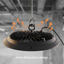 A black hanging industrial light fixture with a ribbed heat-dissipating base, shown against a blurred gray warehouse background with orange airflow arrows and the text 'Heat dissipation design'.