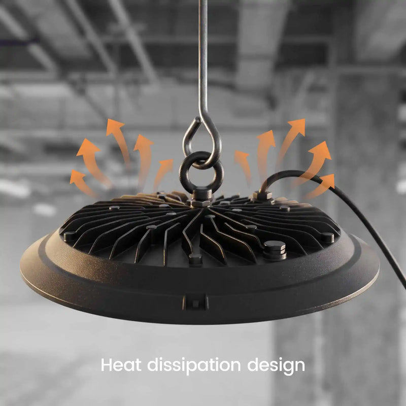 A black hanging industrial light fixture with a ribbed heat-dissipating base, shown against a blurred gray warehouse background with orange airflow arrows and the text 'Heat dissipation design'.