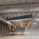 A long rectangular black LED light bar hanging from two black ceiling mounts in an industrial warehouse space. Orange arrows and the text 'Heat dissipation design' are overlaid below the light bar to explain ventilation.