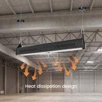 A long rectangular black LED light bar hanging from two black ceiling mounts in an industrial warehouse space. Orange arrows and the text 'Heat dissipation design' are overlaid below the light bar to explain ventilation.