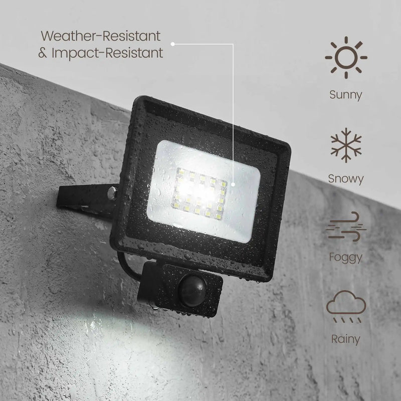 Black outdoor LED floodlight with a built-in motion sensor, mounted on a gray concrete wall. The image includes text and icons indicating weather resistance and suitability for sunny, snowy, foggy, and rainy conditions.