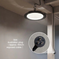 A circular black hanging light fixture with a glowing white diffuser is shown installed on a ceiling in a real interior space. A circular inset highlights the Australian plug and exposed cable, with text reading 'SAA Australian plug (Approx.