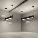 Two black rectangular LED grow lights hanging from ceiling fixtures in a minimalist gray room, with white dimension arrows and text labels showing height measurements of 105mm and 1570mm.