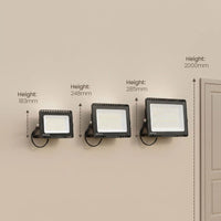 Three black wall-mounted LED floodlights shown on a beige wall with height measurement labels and arrows indicating 183mm, 248mm, 285mm, and 2000mm.