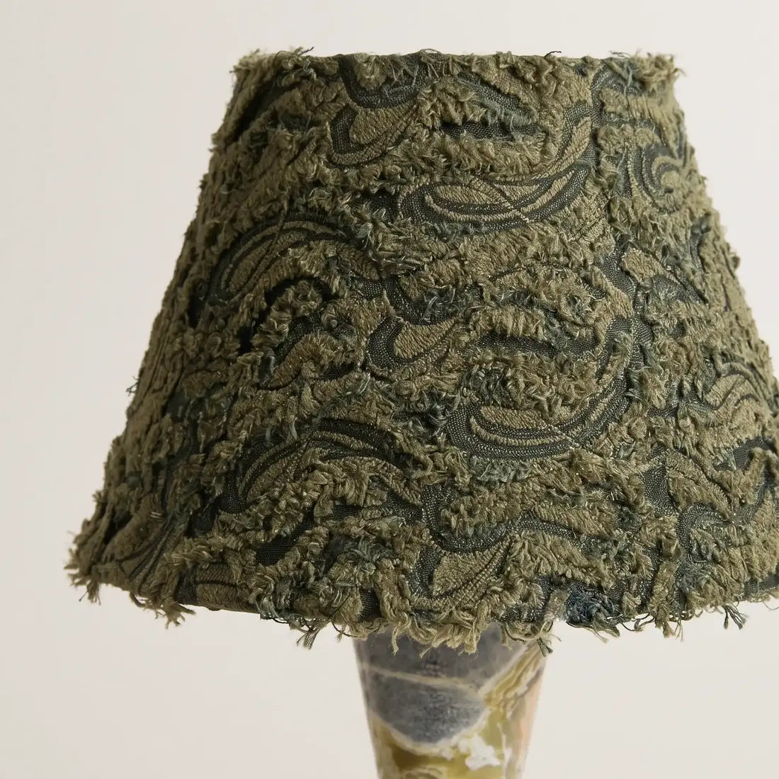 Close-up of the olive green knitted jacquard fabric shade on the Forest Ember table lamp