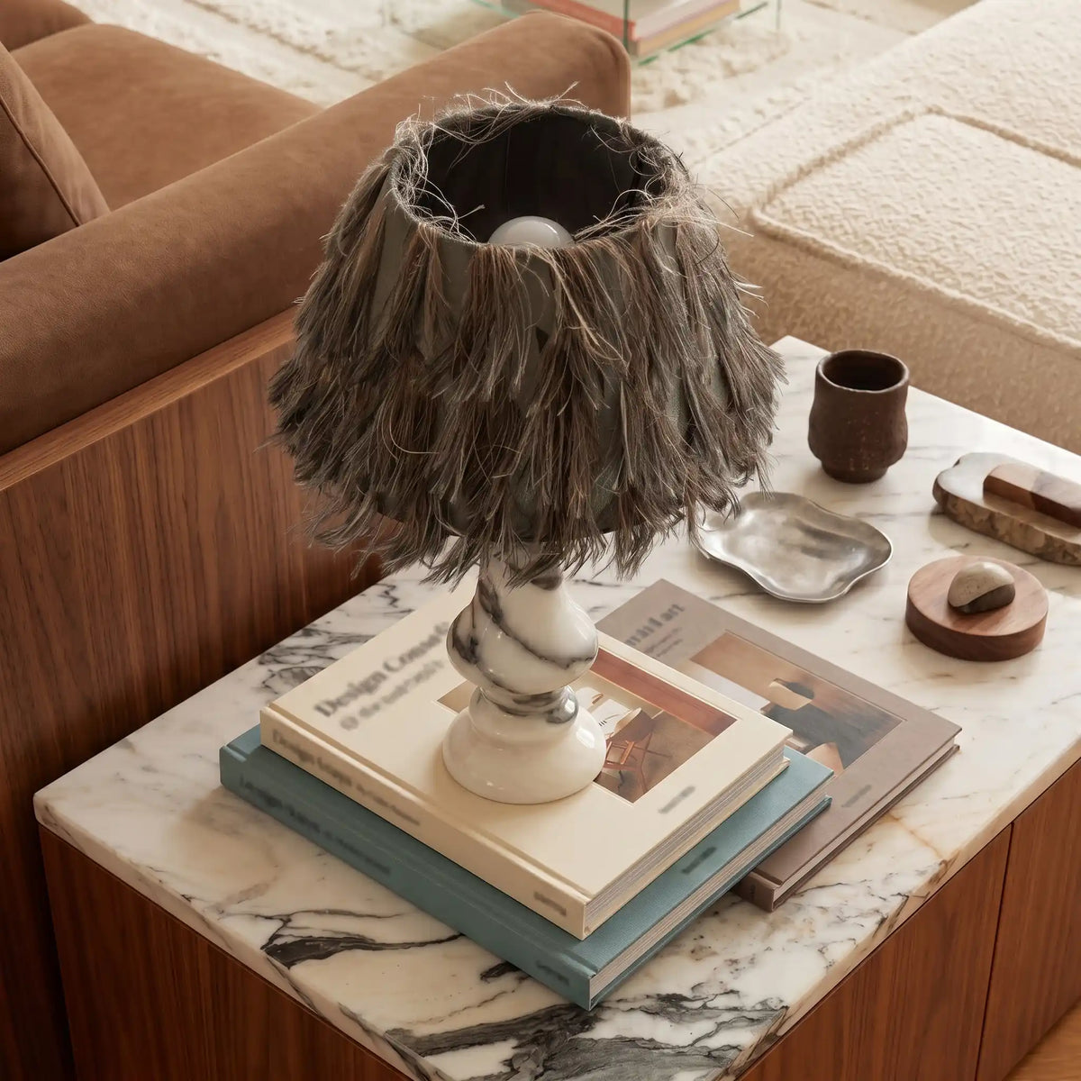 Freehand Arabescato Marble Table Lamp styled on a marble-top table with books and decor