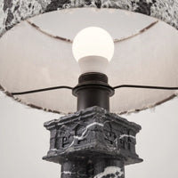 Close-up of the E27 bulb and lamp holder above the carved Black Vein Marble base of Silent Rift