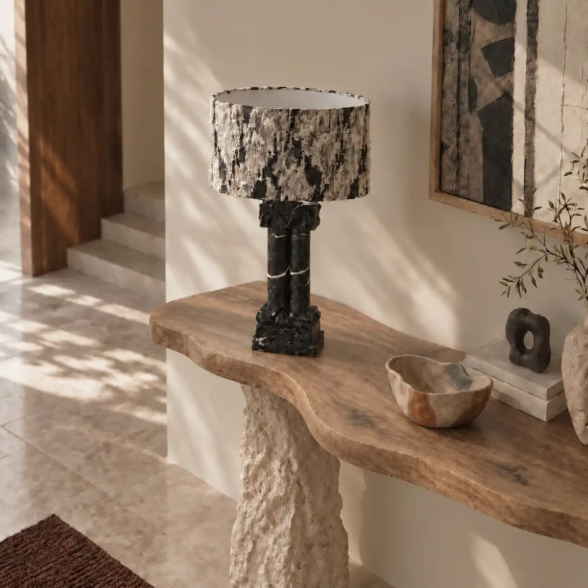 Silent Rift Black Vein Marble table lamp on a sculptural wood console in a sunlit interior