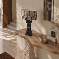Silent Rift Black Vein Marble table lamp on a sculptural wood console in a sunlit interior