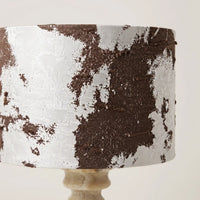 Close-up of natural Tiramisu Travertine veining and hand-carved base of Desert Veil lamp