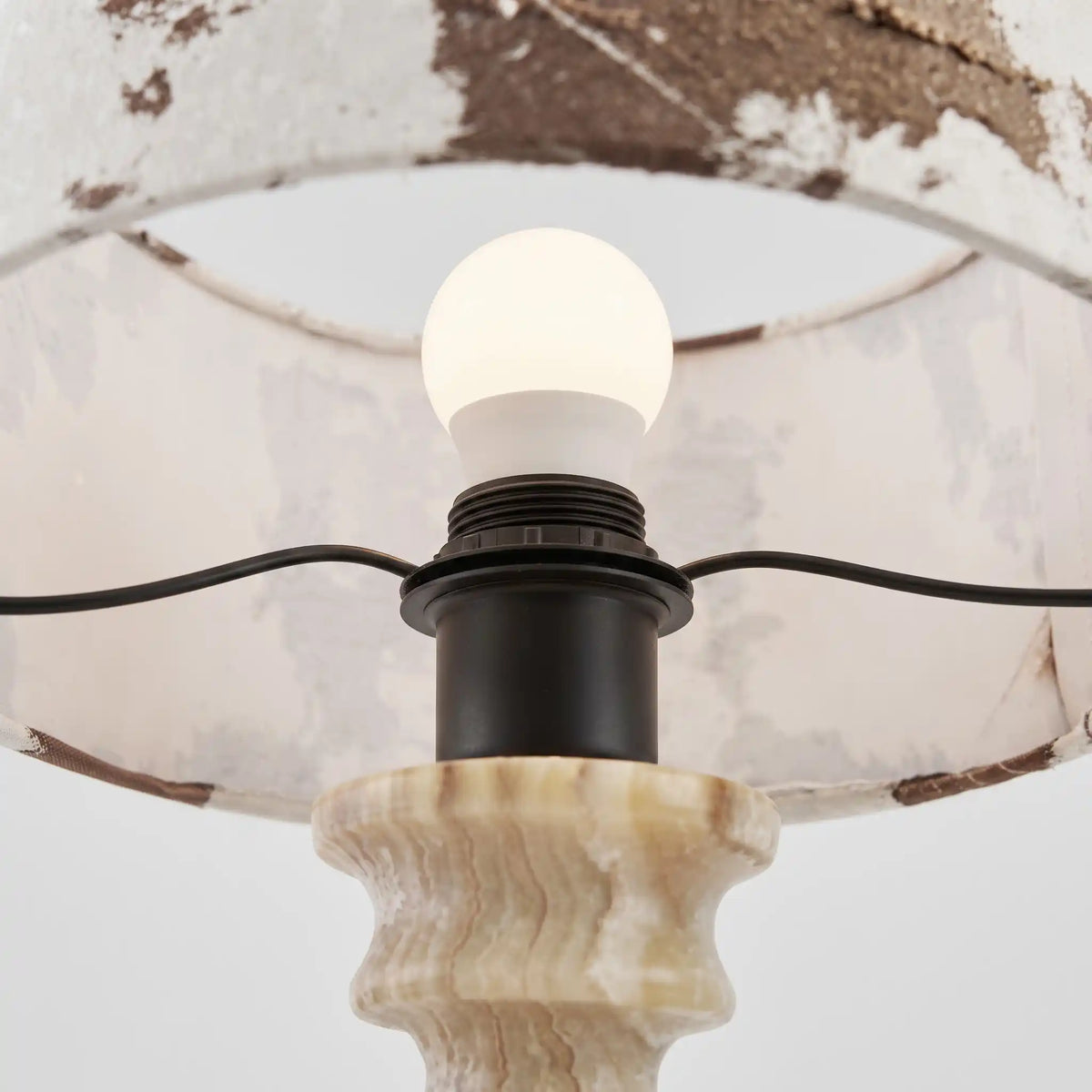 Close-up of bulb and lamp holder inside the Desert Veil patterned fabric shade
