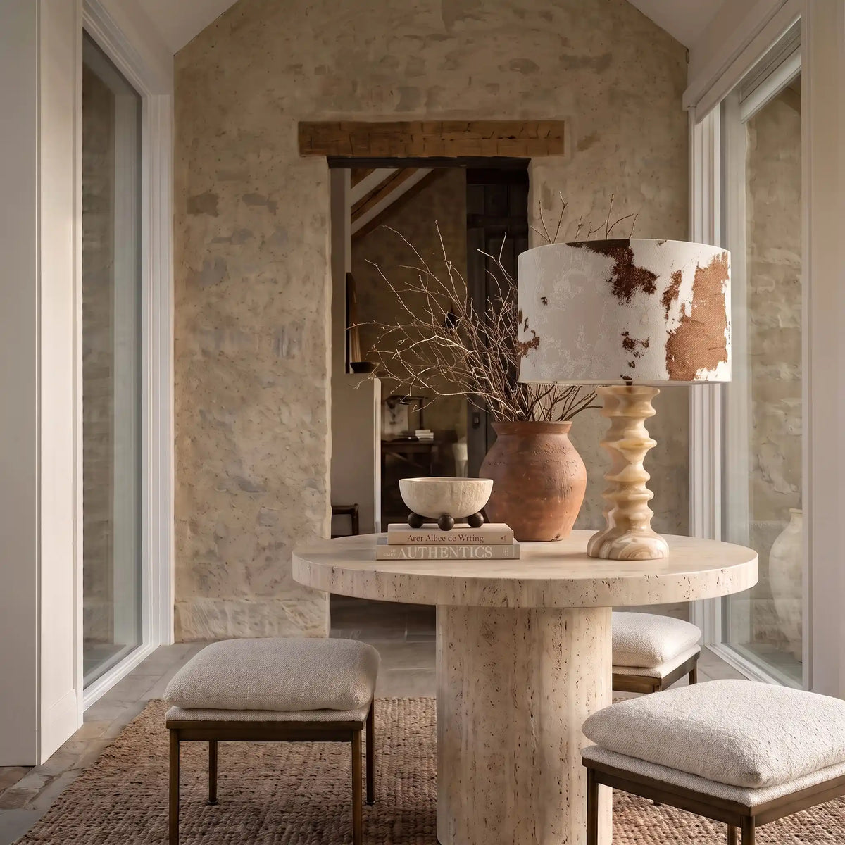 Desert Veil sculptural travertine table lamp styled on a stone dining table