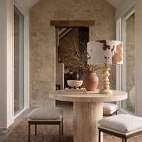 Desert Veil sculptural travertine table lamp styled on a stone dining table